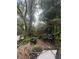 View of backyard with wheelbarrow and two chairs at 7506 Mott Ave, Orlando, FL 32810