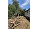 The backyard is overgrown with weeds and scattered debris, showing the exterior of the home at 7506 Mott Ave, Orlando, FL 32810