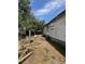 The overgrown backyard features a trailer, scattered debris, and an unkempt lawn at 7506 Mott Ave, Orlando, FL 32810