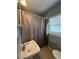Functional bathroom featuring a classic sink and a shower/tub combination with a curtain at 7506 Mott Ave, Orlando, FL 32810
