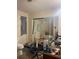 Bathroom with toilet, shower, wallpaper, and clutter on the counter at 7506 Mott Ave, Orlando, FL 32810