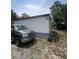 Side view of a weathered home with a truck parked nearby and sparse vegetation at 7506 Mott Ave, Orlando, FL 32810