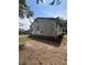 Shows the weathered exterior of a home with siding in need of repair and minimal landscaping at 7506 Mott Ave, Orlando, FL 32810