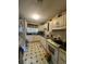 Functional kitchen featuring white appliances and ample cabinet space with checkered tile flooring at 7506 Mott Ave, Orlando, FL 32810