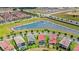 Overhead shot of backyard pools in an attractive neighborhood with views of a landscaped lake at 8210 Topsail Pl, Winter Garden, FL 34787