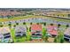 Aerial view showcasing backyard pools in an attractive neighborhood, overlooking a landscaped lake at 8210 Topsail Pl, Winter Garden, FL 34787