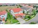 Aerial view of a charming home with a red tile roof, a manicured lawn, and a two-car garage at 8210 Topsail Pl, Winter Garden, FL 34787
