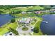 Aerial of luxury community featuring a pool, lake access, and golf course views at 8210 Topsail Pl, Winter Garden, FL 34787