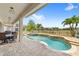 Backyard featuring pool, spa, covered patio, and lush landscaping at 8210 Topsail Pl, Winter Garden, FL 34787