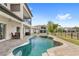 Backyard featuring pool, spa, covered patio, and beautifully paved surroundings at 8210 Topsail Pl, Winter Garden, FL 34787