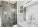 Bathroom with tiled walk-in shower, white vanity, and modern fixtures at 8210 Topsail Pl, Winter Garden, FL 34787