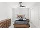 Bright bedroom with neutral tones, wood furnishings, and ample closet space at 8210 Topsail Pl, Winter Garden, FL 34787
