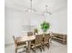 Bright dining room with modern lighting fixtures, a wooden dining table, and a view of the landscaped yard at 8210 Topsail Pl, Winter Garden, FL 34787