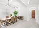 Bright dining room with modern light fixtures, a wooden dining table, and a view of the entry door at 8210 Topsail Pl, Winter Garden, FL 34787