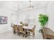 Bright dining room with contemporary lighting, a large window, and stylish decor, creating a welcoming atmosphere at 8210 Topsail Pl, Winter Garden, FL 34787
