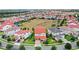 Aerial shot of a beautiful neighborhood displaying houses with manicured lawns and red tiled roofs at 8210 Topsail Pl, Winter Garden, FL 34787