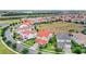 Beautiful community showcasing well-manicured lawns and houses with red tile roofs at 8210 Topsail Pl, Winter Garden, FL 34787