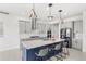 Modern kitchen with gray cabinets, stainless steel appliances, and an island with seating, perfect for cooking at 8210 Topsail Pl, Winter Garden, FL 34787