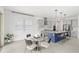 Modern eat-in kitchen with a glass table, bar stool seating at the island, and stainless steel appliances at 8210 Topsail Pl, Winter Garden, FL 34787