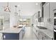 Modern kitchen featuring a large island with bar seating, stainless steel appliances, and views of the backyard pool at 8210 Topsail Pl, Winter Garden, FL 34787