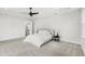 Neutral toned main bedroom showcases plush carpeting, two windows and contemporary ceiling fan at 8210 Topsail Pl, Winter Garden, FL 34787