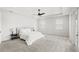 Bright main bedroom boasts neutral walls, plush carpet, and a modern ceiling fan at 8210 Topsail Pl, Winter Garden, FL 34787
