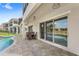 Inviting covered patio with stone flooring and a view of the sparkling pool at 8210 Topsail Pl, Winter Garden, FL 34787