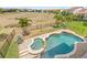 Aerial view of backyard featuring a pool, spa, and lush landscaping at 8210 Topsail Pl, Winter Garden, FL 34787