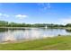 A well-manicured backyard with a large lake view and fountain at 850 Spring Oak Cir, Orlando, FL 32828