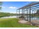 A well-manicured backyard with a pool, screened-in patio, and lake view at 850 Spring Oak Cir, Orlando, FL 32828