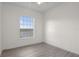 Bright bedroom features wood-look flooring and a window overlooking the backyard at 850 Spring Oak Cir, Orlando, FL 32828
