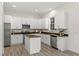 Well-lit kitchen with white cabinets, stainless steel appliances, and a center island with a dark countertop at 850 Spring Oak Cir, Orlando, FL 32828