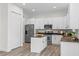 Spacious kitchen features modern appliances, white cabinetry, dark countertops, and a convenient center island at 850 Spring Oak Cir, Orlando, FL 32828