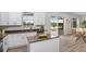 Stylish kitchen with white cabinets, stainless steel appliances, island and view of the pool and backyard at 850 Spring Oak Cir, Orlando, FL 32828