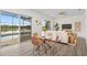 Cozy living space adjacent to dining area with sliding glass doors to the screened-in patio and lake view at 850 Spring Oak Cir, Orlando, FL 32828