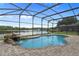A screened-in pool with a water feature overlooks a large lake at 850 Spring Oak Cir, Orlando, FL 32828