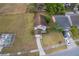 Aerial view of the home, showcasing the roof, landscaping, and proximity to neighbors and street at 9316 Dubois Blvd, Orlando, FL 32825