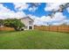 Spacious, fenced backyard with green grass and mature trees at 9316 Dubois Blvd, Orlando, FL 32825