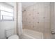 Bathroom with white tile, a bathtub and shower combination at 9316 Dubois Blvd, Orlando, FL 32825