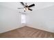 This bedroom has a ceiling fan and neutral carpeting at 9316 Dubois Blvd, Orlando, FL 32825