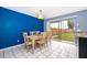 Well-lit dining space with a table and chairs, flowing seamlessly to the kitchen and backyard, ideal for gatherings at 9316 Dubois Blvd, Orlando, FL 32825