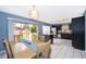 Charming dining area with table set, large window views, and access to kitchen, ideal for entertaining guests at 9316 Dubois Blvd, Orlando, FL 32825
