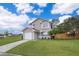 Charming two-story home featuring a well-manicured lawn and an attached one-car garage at 9316 Dubois Blvd, Orlando, FL 32825