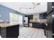 Updated kitchen featuring stainless steel appliances, dark cabinetry, neutral countertops, and ample natural light at 9316 Dubois Blvd, Orlando, FL 32825