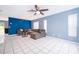 Spacious living area featuring comfortable seating, tile flooring, and neutral tones, creating a welcoming atmosphere at 9316 Dubois Blvd, Orlando, FL 32825