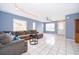 Open living room with neutral walls, tile flooring, and a comfortable seating arrangement, filled with natural light at 9316 Dubois Blvd, Orlando, FL 32825