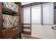 Custom walk-in closet with wood shelving, drawers, hanging rods, and colorful storage baskets at 9316 Dubois Blvd, Orlando, FL 32825