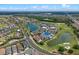 Beautiful aerial view of homes in a luxury community near a golf course, ponds, and lush vegetation at 960 Golden Bear Dr, Reunion, FL 34747