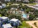 A captivating aerial view of the community pool, lush landscaping, and inviting amenities for endless relaxation and recreation at 960 Golden Bear Dr, Reunion, FL 34747