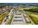 Scenic aerial view featuring a gorgeous golf course, residential neighborhoods, and serene lake at 960 Golden Bear Dr, Reunion, FL 34747